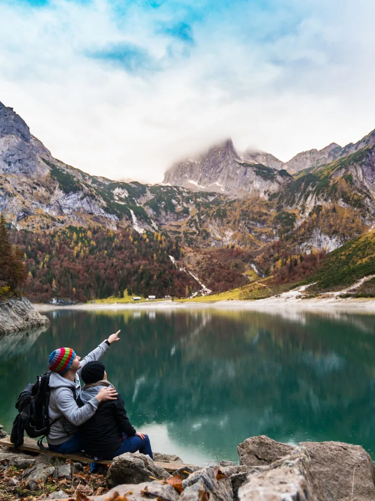 a couple looking up into the mountains
