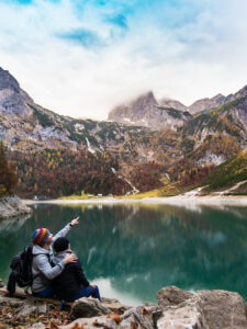 a couple looking up into the mountains